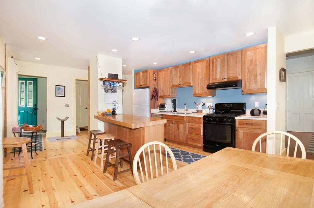 First-floor renovation of a 19th-century farmhouse in Amherst, Massachusetts featuring an updated kitchen, accessible bathroom, restored living spaces, and improved interior layout.