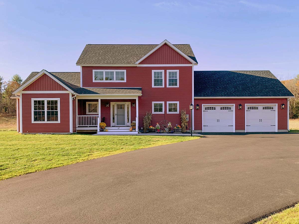 Photograph of an Aging-in-Place custom home with an attached garage and detached outbuilding built by Integrity Development & Construction in Southampton, MA.