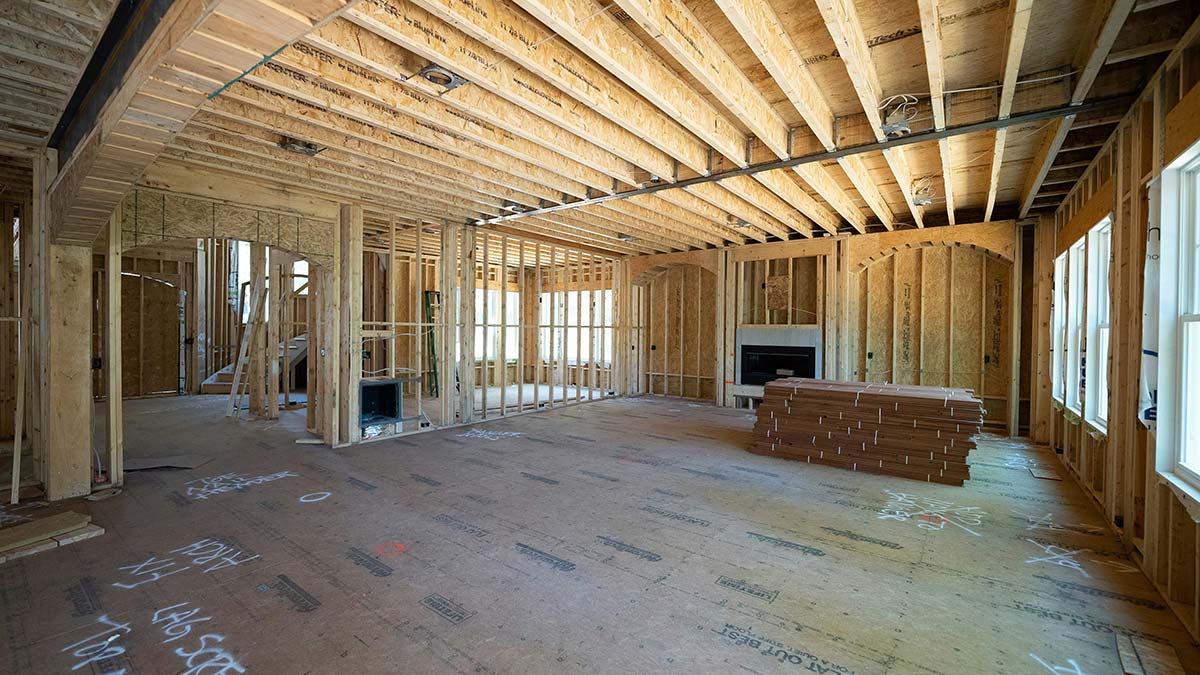 Interior framing of a Massachusetts home addition mid-construction, the stage where building permit inspections occur before walls are closed