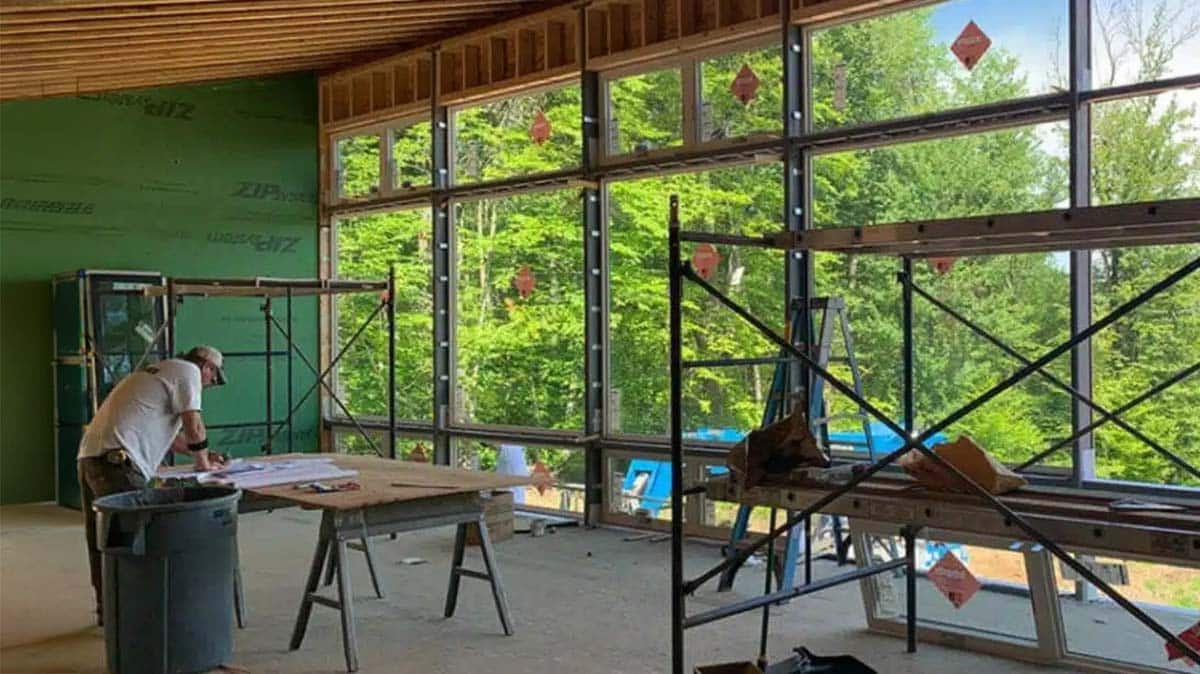 Integrity team member reviewing construction plans during the design-build construction process in Western Massachusetts.